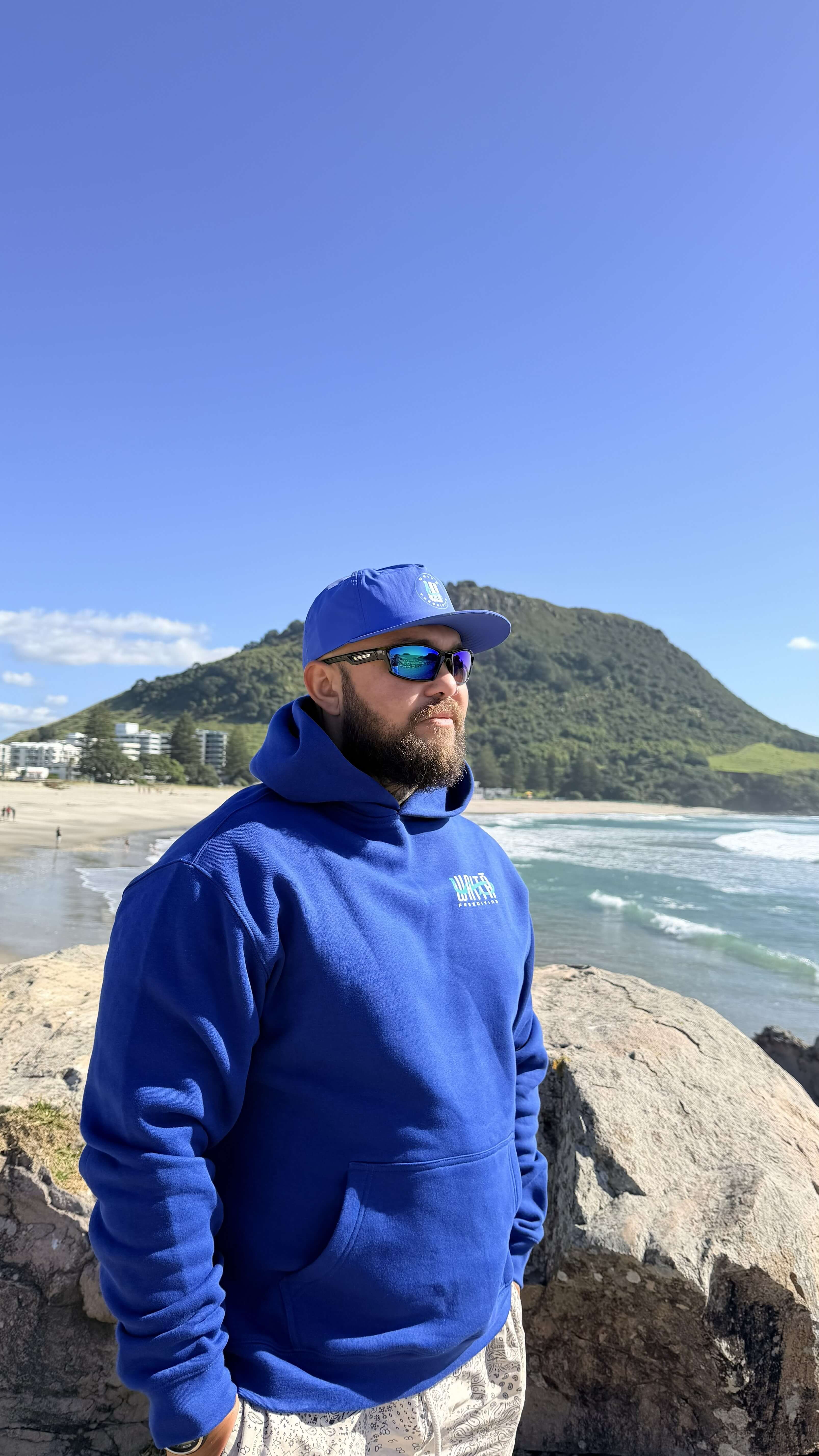 Waitā Poraka hoodie in kikorangi, front view