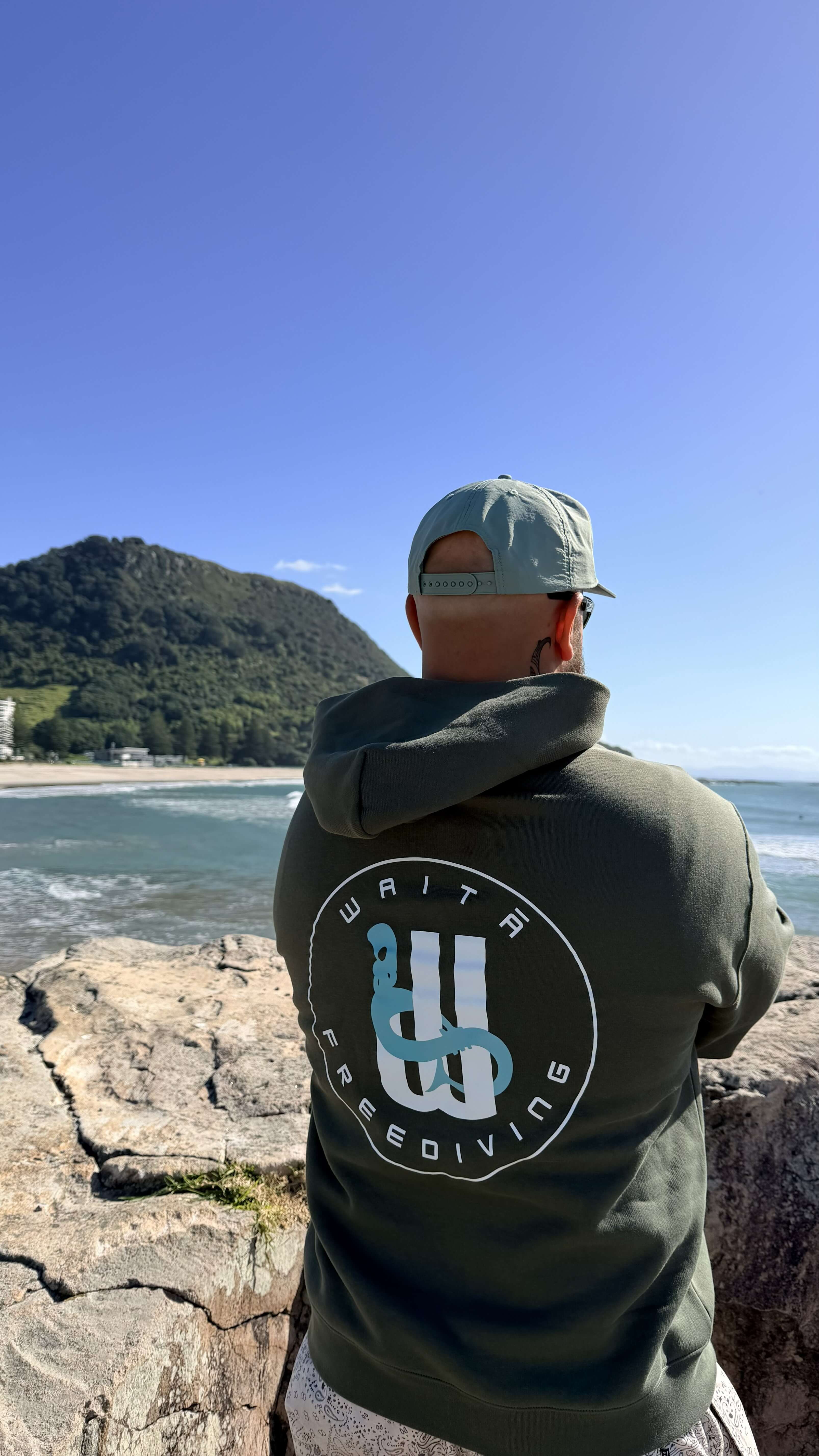 Waitā Poraka hoodie in kākāriki, back view
