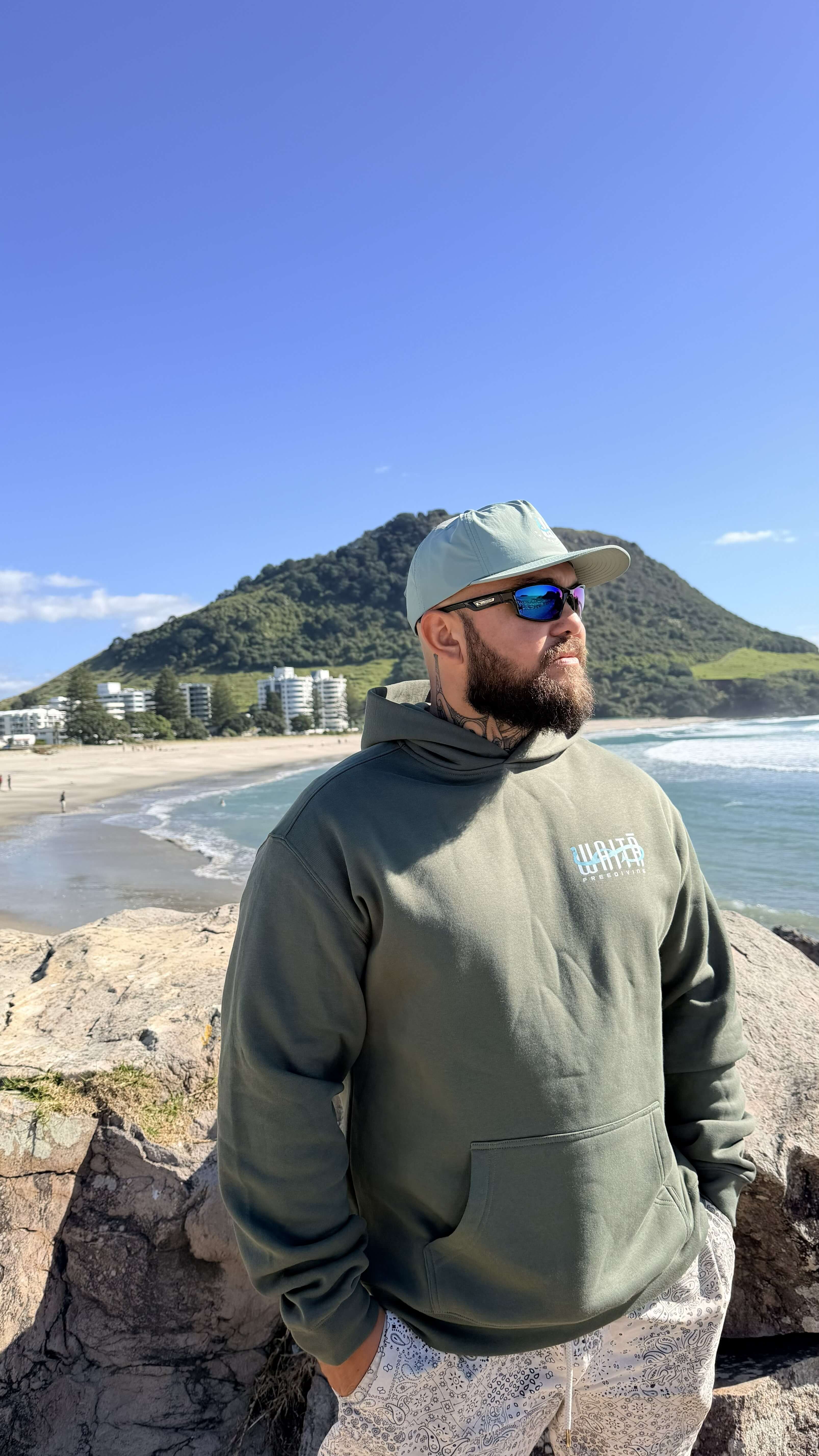 Waitā Poraka hoodie in kākāriki, front view