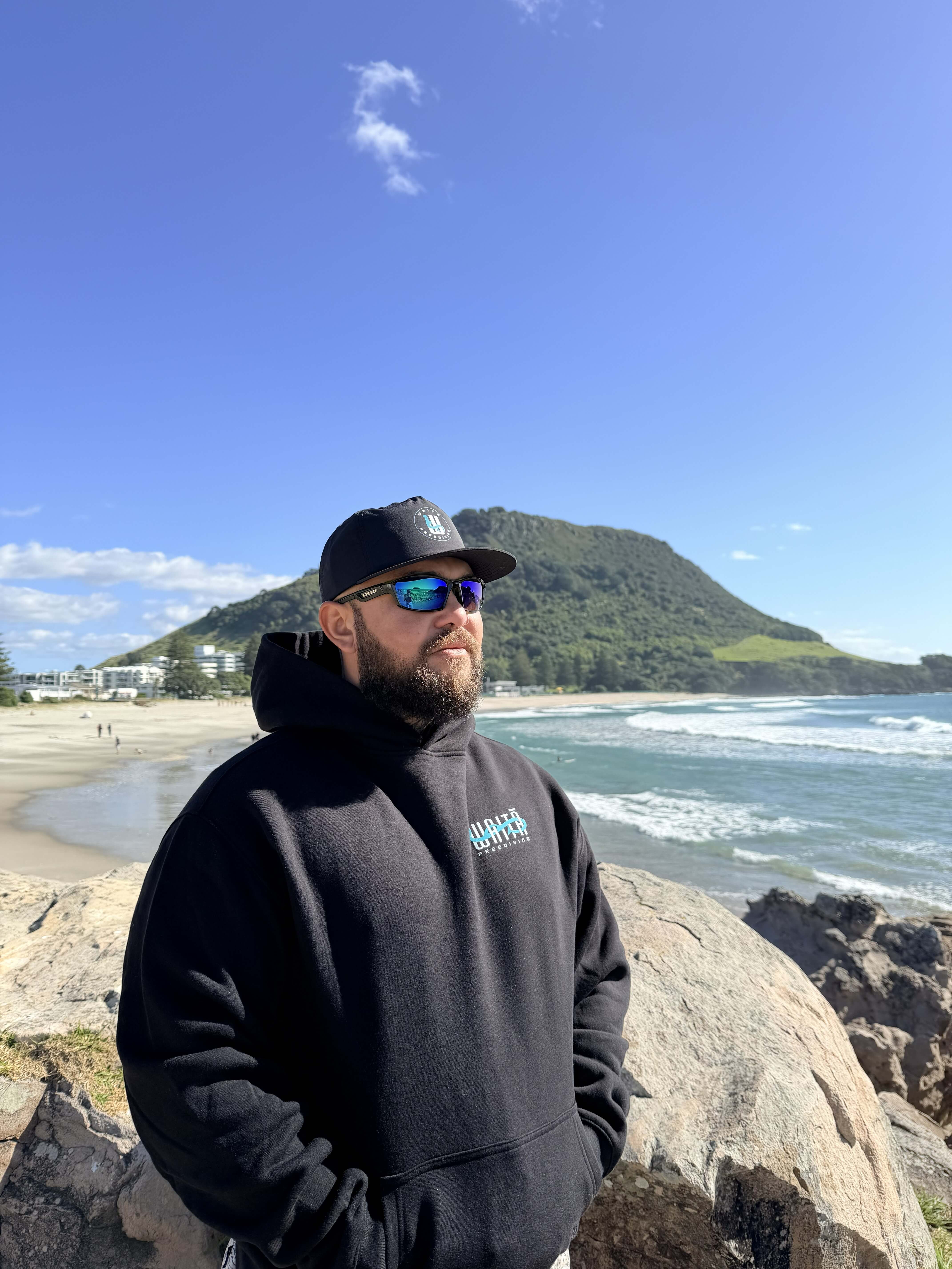 Waitā Poraka hoodie in pango, front view